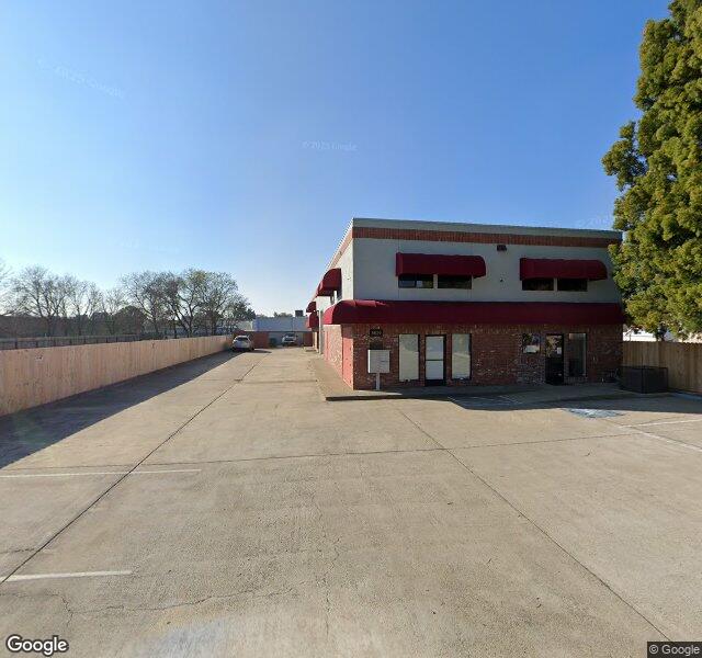 Brick commercial building with red trim on Davis Road, viewed from the parking lot